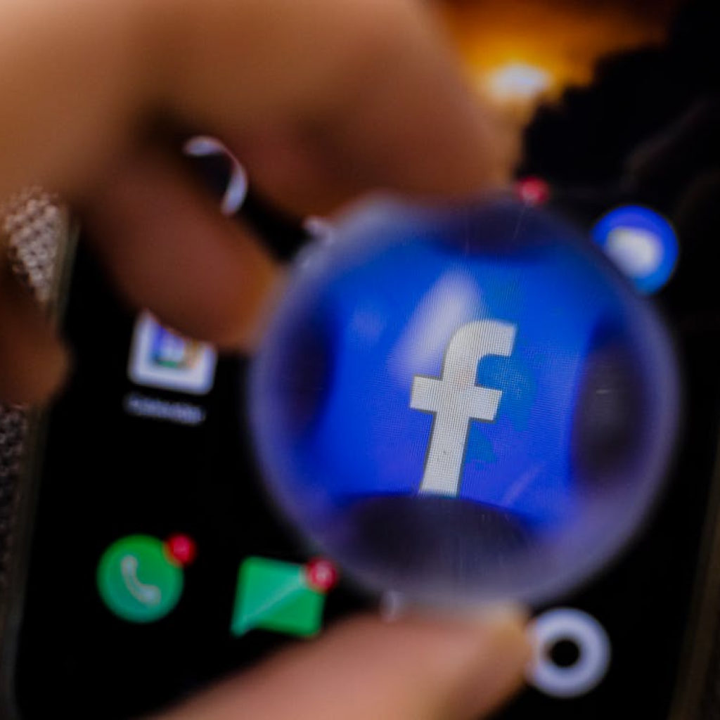 Close-up shot of a smartphone with a Facebook app magnified