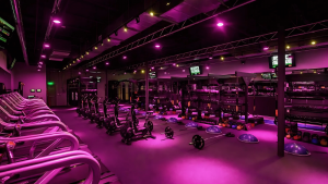 2025-ods-new-page-website-gym-design-ideas- a gym with cardio machines and pink lighting designed by optimal design systems international